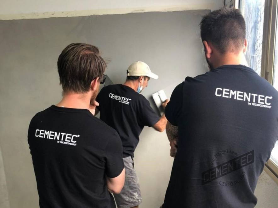 Students of Cementec's course for microcement applicators observing an example of application by an instructor.